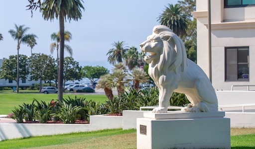 Image of the lion statue on campus, the weather the day this was taken was great, the sky is blue and it looks a cool 75 degrees and sunny
